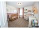 Well-lit Bedroom with a crib, changing table, comfortable chair, and whimsical decorations at 18297 Rickety Dr, Westfield, IN 46074