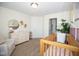 Bright Bedroom featuring a wooden crib, dresser with changing station, and neutral decor at 18297 Rickety Dr, Westfield, IN 46074