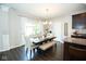 Inviting dining area featuring a chandelier, patio access, and neutral colors at 18297 Rickety Dr, Westfield, IN 46074