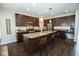 Spacious kitchen featuring stainless steel appliances, granite countertops, and dark wood cabinets at 18297 Rickety Dr, Westfield, IN 46074