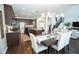 Open kitchen with modern cabinets, granite countertops, and a view of the dining area at 18297 Rickety Dr, Westfield, IN 46074