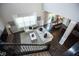 Open-concept living room featuring dark hardwood floors, large windows, and a view of the dining area at 18297 Rickety Dr, Westfield, IN 46074