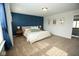 Spacious main bedroom with blue accent wall, large windows, and framed photographs on the white wall at 18297 Rickety Dr, Westfield, IN 46074