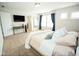 Bright main bedroom with a view of the ensuite bathroom, large windows, and neutral decor at 18297 Rickety Dr, Westfield, IN 46074