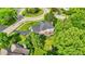 Overhead view of a brick home with spacious yard, trees and landscaping in a suburban neighborhood at 1898 Corniche Dr, Zionsville, IN 46077