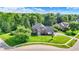 Beautiful aerial view of a two-story home with a well manicured lawn in a green community at 1898 Corniche Dr, Zionsville, IN 46077