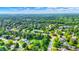 Vibrant aerial showcases a neighborhood with mature trees, manicured lawns, winding streets, and a tranquil lake at 1898 Corniche Dr, Zionsville, IN 46077
