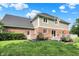 Expansive backyard with a well-maintained lawn, deck, and vibrant flowerbeds at 1898 Corniche Dr, Zionsville, IN 46077