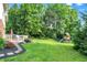 Lush backyard with a deck and a playhouse with a slide at 1898 Corniche Dr, Zionsville, IN 46077