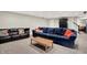 Finished basement featuring two couches, a wooden coffee table and staircase at 1898 Corniche Dr, Zionsville, IN 46077
