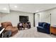 Finished basement with a gray carpet and a black TV over shelves at 1898 Corniche Dr, Zionsville, IN 46077