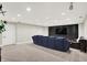 Basement entertainment space with a plush sofa, black accent wall, and mounted TV at 1898 Corniche Dr, Zionsville, IN 46077