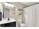 Cozy bathroom featuring a stylish vanity, toilet, decorative shelf and a shower with a white curtain at 1898 Corniche Dr, Zionsville, IN 46077