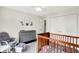 Well lit Bedroom with hardwood floors features a crib, changing table and gray glider at 1898 Corniche Dr, Zionsville, IN 46077