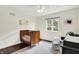 Bright Bedroom features a wood crib, hardwood floors, and a large window providing ample natural light at 1898 Corniche Dr, Zionsville, IN 46077