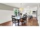 Open dining room with hardwood floors, wainscotting, and views into the kitchen featuring an island with seating at 1898 Corniche Dr, Zionsville, IN 46077