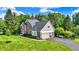 View of home featuring an attached two-car garage and well maintained lawn at 1898 Corniche Dr, Zionsville, IN 46077