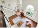 Bright foyer with hardwood floors, staircase, and view of the living room featuring a sofa and fireplace at 1898 Corniche Dr, Zionsville, IN 46077