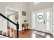 Inviting foyer featuring hardwood floors, a high ceiling, and a white front door at 1898 Corniche Dr, Zionsville, IN 46077