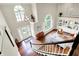 Grand foyer with hardwood floors, large windows, elegant chandelier, and a view of the living spaces at 1898 Corniche Dr, Zionsville, IN 46077