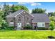 Charming two-story brick home with a well-manicured lawn and lush landscaping at 1898 Corniche Dr, Zionsville, IN 46077