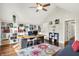Bright office with hardwood floors, built-in bookshelves, and a ceiling fan at 1898 Corniche Dr, Zionsville, IN 46077