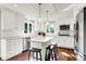 Bright kitchen featuring white cabinets, stainless steel appliances, an island with seating, and subway tile backsplash at 1898 Corniche Dr, Zionsville, IN 46077