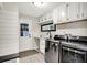Well-equipped laundry room featuring modern washer and dryer, white cabinetry, and convenient utility sink at 1898 Corniche Dr, Zionsville, IN 46077
