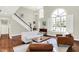 Bright living room features hardwood floors, fireplace, custom built-ins, and large windows at 1898 Corniche Dr, Zionsville, IN 46077