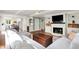 Bright living room features a fireplace, built-in shelving, recessed lighting, and an open layout with hardwood floors at 1898 Corniche Dr, Zionsville, IN 46077