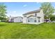This home's back exterior features a large yard and a sunroom, perfect for relaxation at 1903 Windy Hill Ln, Indianapolis, IN 46239