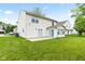 Home's back exterior features a patio and well-maintained lawn, ideal for outdoor activities at 1903 Windy Hill Ln, Indianapolis, IN 46239
