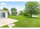 Expansive backyard with lush lawn, mature trees, and patio, offering a serene outdoor retreat at 1903 Windy Hill Ln, Indianapolis, IN 46239