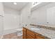 Bathroom featuring a granite countertop, wood cabinets, tile floors and a tub and shower combo at 1903 Windy Hill Ln, Indianapolis, IN 46239