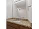 Bathroom vanity with granite countertop, sink, large mirror and modern fixtures at 1903 Windy Hill Ln, Indianapolis, IN 46239
