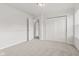A bedroom with neutral carpet, crown molding, double closets and a doorway leading to another room at 1903 Windy Hill Ln, Indianapolis, IN 46239