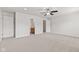 A carpeted bedroom features a ceiling fan, a bathroom entrance, and a closet at 1903 Windy Hill Ln, Indianapolis, IN 46239