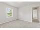 This bedroom features a light neutral carpet, a window, and a doorway to another room at 1903 Windy Hill Ln, Indianapolis, IN 46239