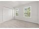 A simple bedroom with plush neutral carpeting, an abundance of natural light and a double closet at 1903 Windy Hill Ln, Indianapolis, IN 46239