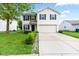 Charming two-story home featuring a well-maintained lawn, a two-car garage, and classic curb appeal at 1903 Windy Hill Ln, Indianapolis, IN 46239