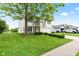 View of two story house with green grass, concrete driveway and landscaping at 1903 Windy Hill Ln, Indianapolis, IN 46239