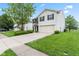 Well-kept two story house with a concrete driveway, green grass and landscaping at 1903 Windy Hill Ln, Indianapolis, IN 46239