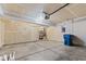 Interior garage featuring concrete floors, door, hot water tank, and electrical panel at 1903 Windy Hill Ln, Indianapolis, IN 46239