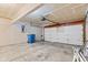 Spacious garage with concrete floor, overhead door, and a blue trash receptacle at 1903 Windy Hill Ln, Indianapolis, IN 46239