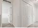Hallway with carpet floors, white doors, and white walls leading to the bedrooms at 1903 Windy Hill Ln, Indianapolis, IN 46239