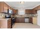 Well-lit kitchen featuring granite countertops, backsplash, and stainless steel appliances at 1903 Windy Hill Ln, Indianapolis, IN 46239