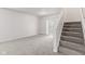 Neutral living room with carpeting, natural light, ceiling fan, and stairway at 1903 Windy Hill Ln, Indianapolis, IN 46239