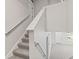 Carpeted staircase with white banister leading to the second floor, bright interior at 1903 Windy Hill Ln, Indianapolis, IN 46239