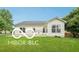 A view of a backyard with well-maintained grass and the back of the home at 19146 Carol Cove Cir, Noblesville, IN 46062
