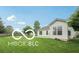 An exterior view of a backyard and patio area surrounded by a lush green lawn at 19146 Carol Cove Cir, Noblesville, IN 46062